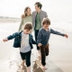 Foto de familia paseando por la playa enfrentando el estres